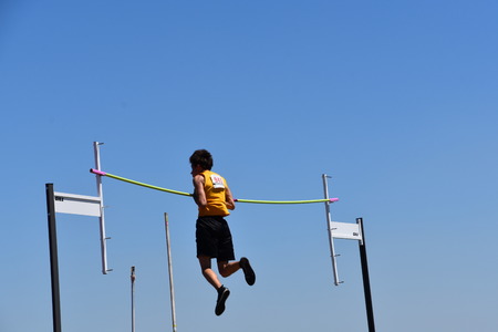 FARGO, NORTH DAKOTA, July 5, 2019: A young  man participates in the pole vault at the Regional  United States Association of Track andField) USATF track meet.のeditorial素材