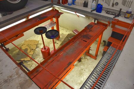 A pit in a filling station where mechanics can work on the underneath part of a vehicleの写真素材