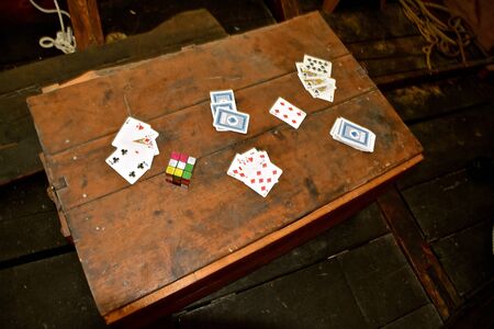 MOORHEAD, MINNESOTA, January 8, 2020: The old Rubik's Cube mixed in the the playing cards is a 3-D combination puzzle invented in 1974 by Hungarian sculptor Emo Rubik.のeditorial素材