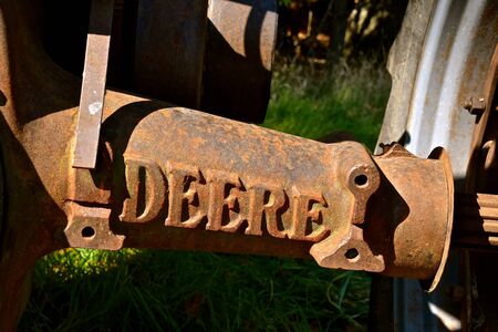 VERGAS, MINNESOTA, October 6, 2019: A casted logo on a axle of an old tractor is a product of John...