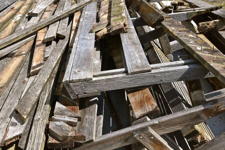 The remains of an outdoor deck is left in a pile of scrap wood.