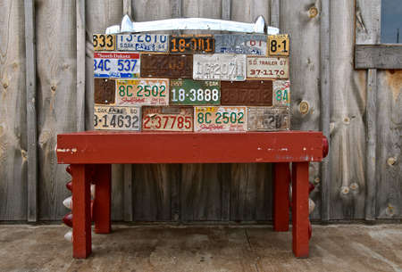 MITCHELL, SOUTH DAKOTA, June 25, 2020: The bench displays different years of license planets distributed by the South Dakota Department of Transportation.のeditorial素材