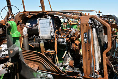 The charred remains of a tractor engine burned in a fire leave parts unrecognizable.