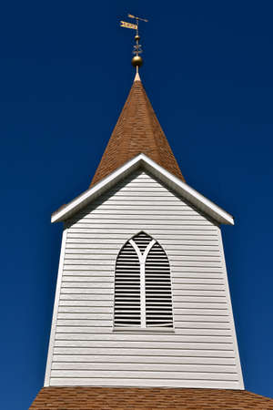 The old country church is modernized with a new vinyl steeple and cross.