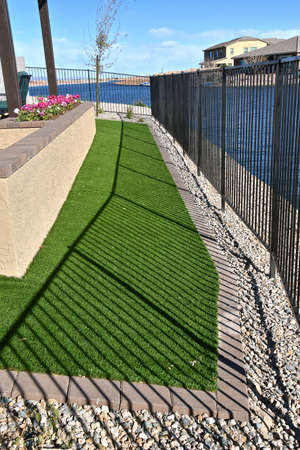 Artificial grass or turf between patio and fenceの写真素材
