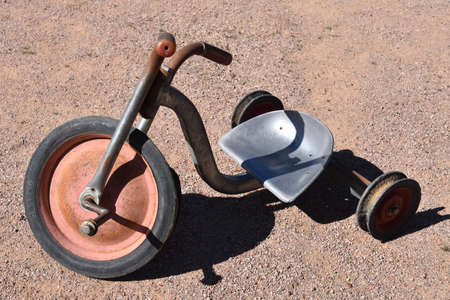 A very old kids tricycle with an aluminum seatの写真素材