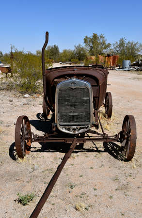 A homemade gadget or machine resembling a car is made from scrap metal with bits and pieces of machines and equipmentの写真素材