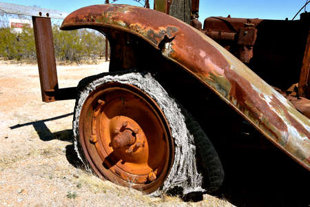 An old fender of a vehicle with a shredded and rotten tireの写真素材