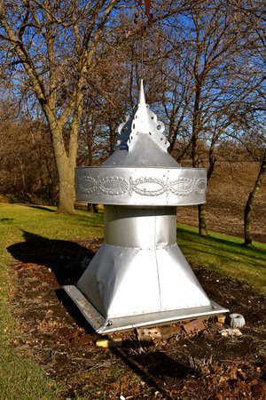 An old barn cupola serves as a yard decorationの写真素材
