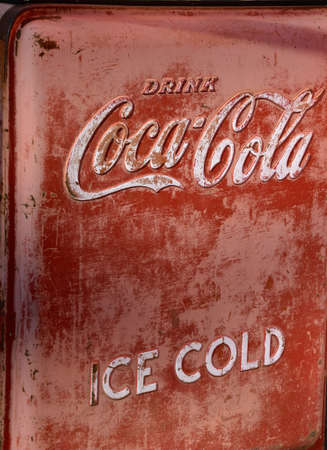 ULEN, MINNESOTA APRIL 9, 2021:The old Coca Cola bottling machine advertises  the soft drink invented by John Pemberton in the late 1800`s is headquartered in Atlanta, GAのeditorial素材