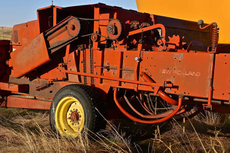 FIRESTEEL,  SOUTH DAKOTA, April 27, 2021: The old baler is a product of New Holland, now a global brand of agricultural machinery produced by CNH Industrial.のeditorial素材