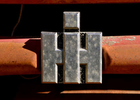 LIDGERWOOD, NORTH DAKOTA, May 9, 2021: The old rusty and tarnished logo is a product of the International Harvester Company which was a United States manufacturer of agricultural machinery, constructiのeditorial素材