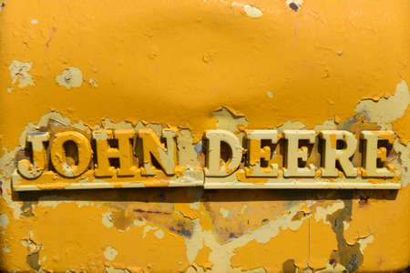 HAVANA, NORTH DAKOTA,  May 9, 2021:  The old re-painted logo  on a tractor is  a product of John Deere Co, an American corporation that manufactures agricultural and construction equipment, drive traiのeditorial素材