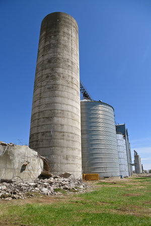 A series of grain elevators including a poured concrete silo which has been demolishedの写真素材