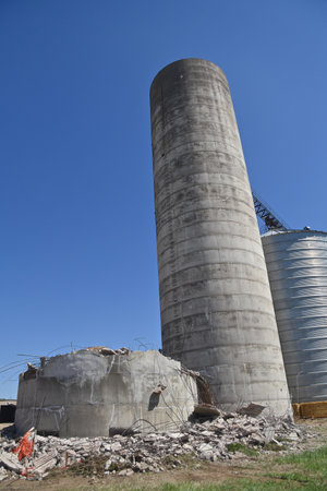 A series of grain elevators including a poured concrete silo which has been demolishedの写真素材