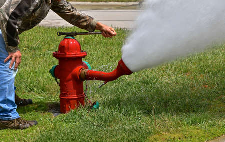 A fire hydrant is being opened as the system is flushed and tested for operational use when needed.の写真素材