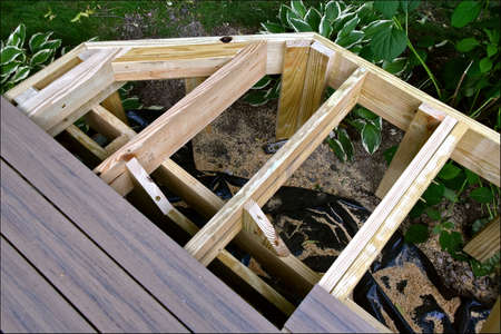A deck is under construction with joists and posts in placeの写真素材