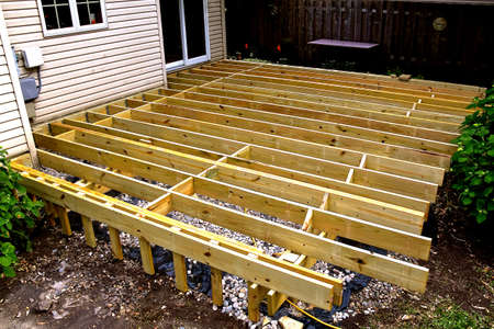 The joists, frame, and posts of a new deck under construction are in place.の写真素材
