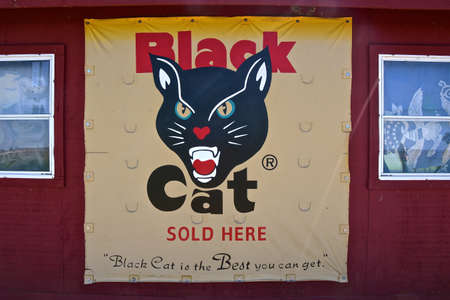 CHURCHS FERRY, September 6, 2022; The old Black Cat fire cracker poster on an outdoor building wall is now owned by Black Cat Fireworks in China.のeditorial素材