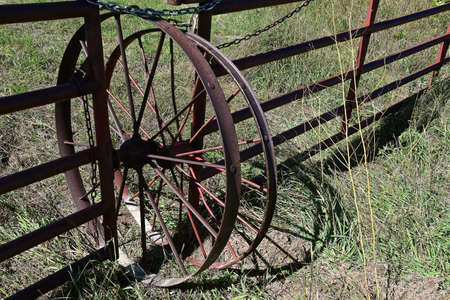 Rolling steel wheels are attached to a metal gate for easier opening and closing.の写真素材