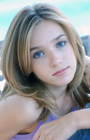 Beautiful young girl with blond hair and blue eyesの写真素材