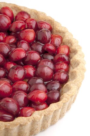 Freshly baked cherry tart with golden crust on white backgroundの写真素材