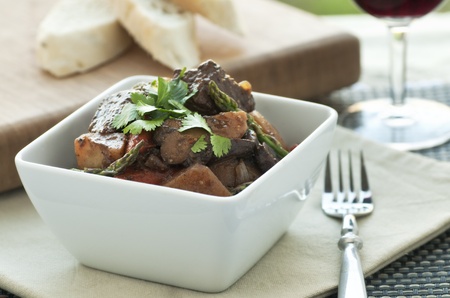 Fresh beef stew with asparagus and cilantro garnishの写真素材
