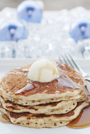 Fresh buttermilk pancakes with scoop of butter on white plateの写真素材