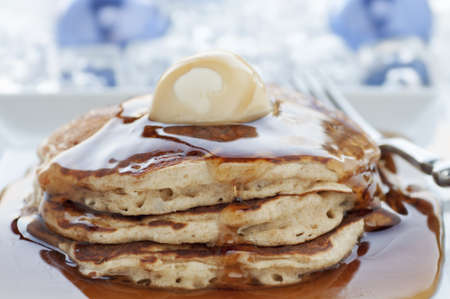 Fresh buttermilk pancakes with scoop of butter on white plateの写真素材