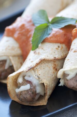 Fresh crepes with chicken sausage and red sauceの写真素材