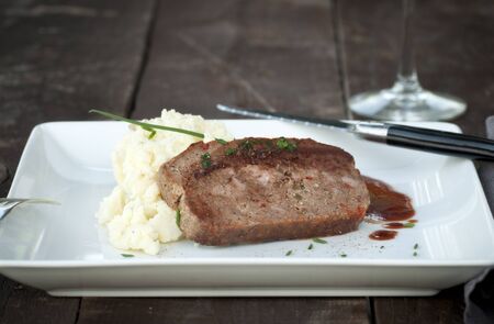 Slice of homemade meat loaf with mashed potatoes and wine sauceの写真素材