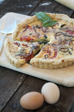 Golden crusted quiche with heirloom tomatoes, onions and herbs