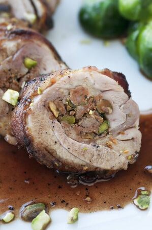 Bacon wrapped chicken thigh stuffed with wine sauce and brussel sproutsの写真素材