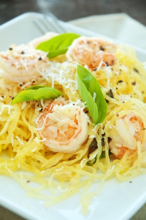 Fresh spaghetti squash with basil and sauteed shrimp in wine sauceの写真素材