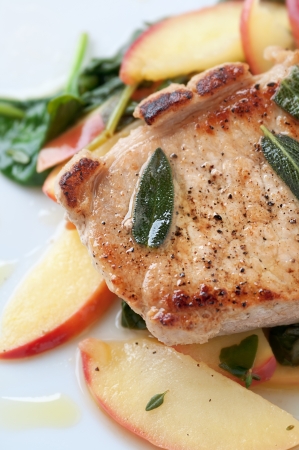 Golden pork chop with warm apple and green saladの写真素材