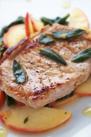 Golden pork chop with warm apple and green saladの写真素材
