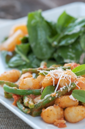 Delicious homemade gnocchi with fresh garden greensの写真素材