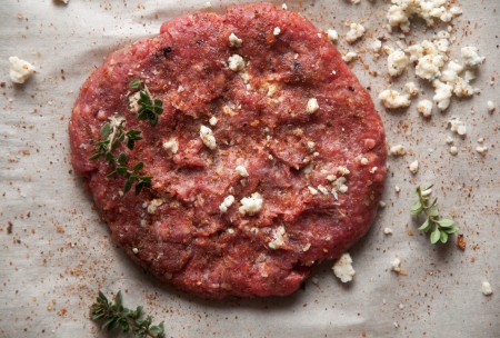 Fresh ground beef patty with gorganzola cheese and seasoning