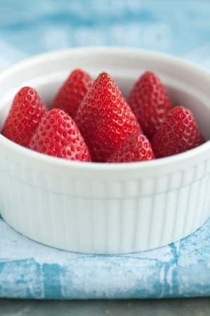 White ramekin of fresh ripe strawberriesの写真素材