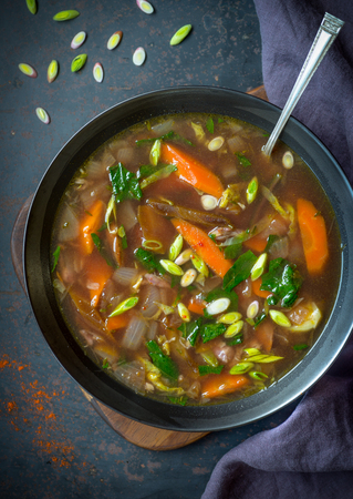 Nourishing bowl of chicken soup with vegetablesの写真素材