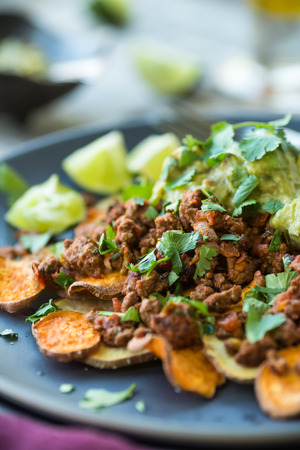 Sweet potato chips with spicy ground turkey nachos and guacamoleの写真素材