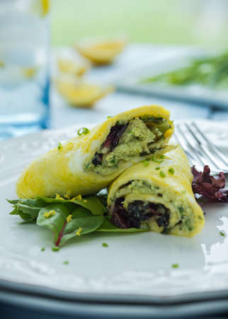 Pesto omelette with mixed greens and chivesの写真素材