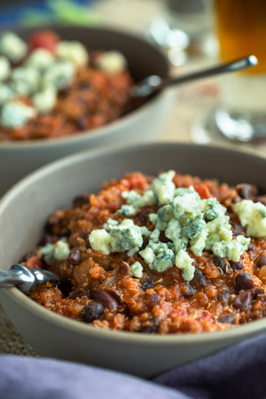 Quinoa chili with vegetables and blue cheese crumblesの写真素材