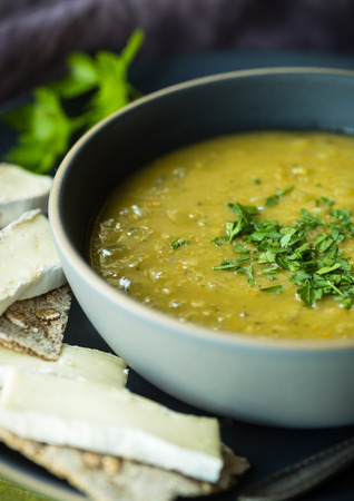 Fresh split pea soup with crackers and brie cheeseの写真素材
