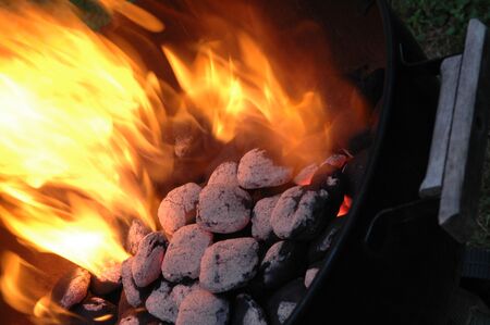 light my fire...charcoal briquets fired up in a kettle grillの写真素材