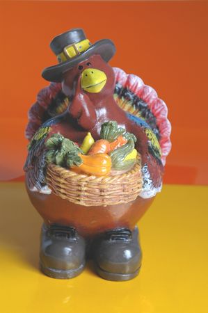 father pilgrim turkey with a bountiful harvest in his basketの写真素材
