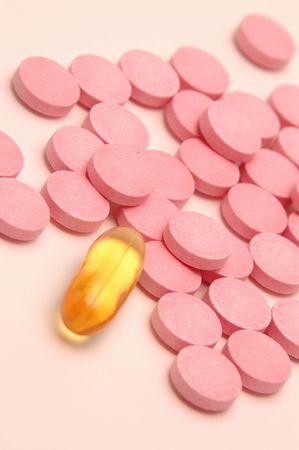 one alone with focus on pink pills just by odd one