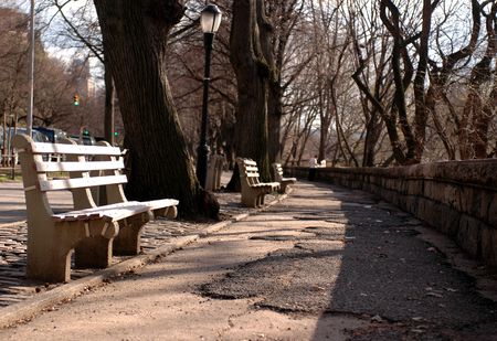 benches in park with focus on closest bench with fadeの写真素材