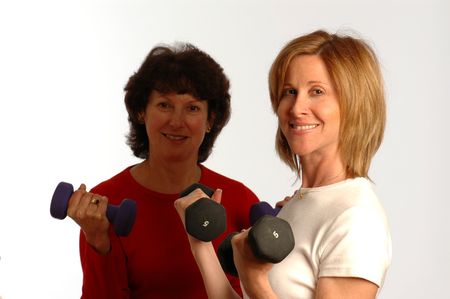 two women in exercise mode with intentional light and focus on instructorの写真素材