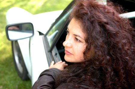 sexy woman in sports car shallow dof with focus on woman